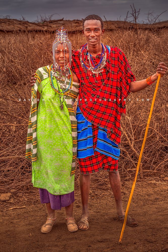 A full body portrait of a Maasai couple in traditional tribal clothing, Kenya, Africa