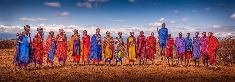 19 Maasai people in traditional clothing performing jumping ritual, Kenya