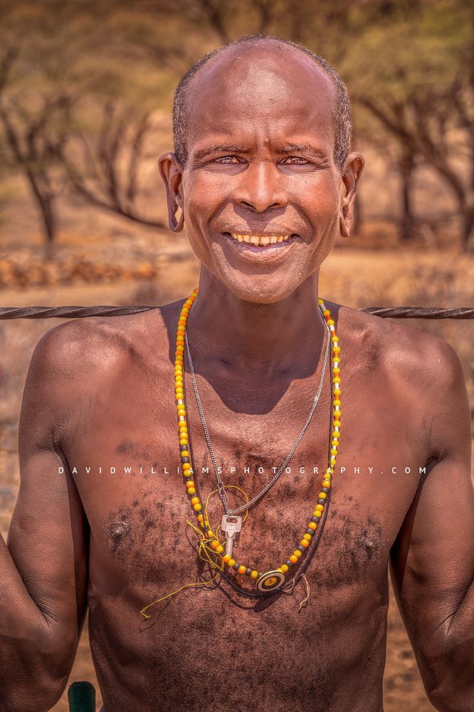 A smiling Maasai male tribesman looking happy, Kenya Africa