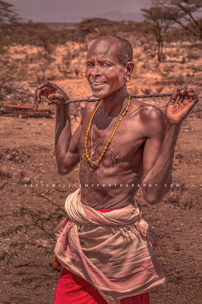 A smiling Maasai male tribesman looking happy, Kenya Africa