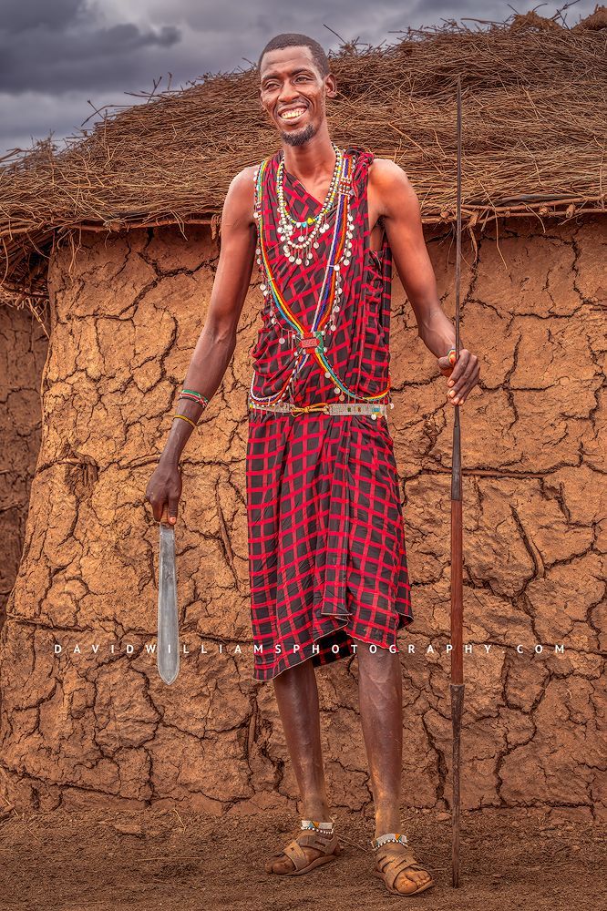 A traditional smiling Maasai Warrior with machete and spear, Kenya