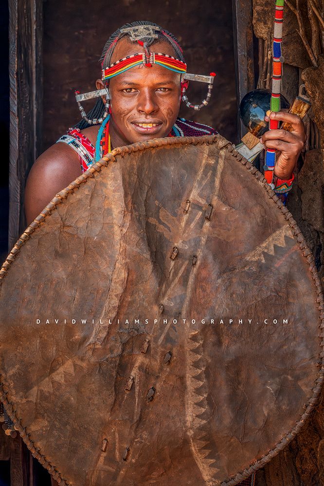 A Maasai Warrior with elongo shield and headdress, Amboseli