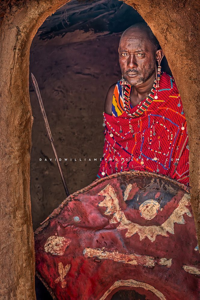 A Maasai Man in the doorway to his mud home, Kenya, Africa