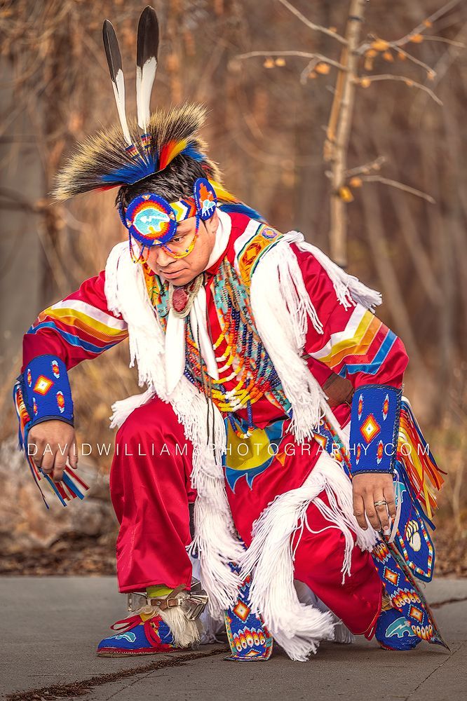Native American man performing the Grass Dance in full regalia during Native American Heritage Month in Salt Lake City, Utah.