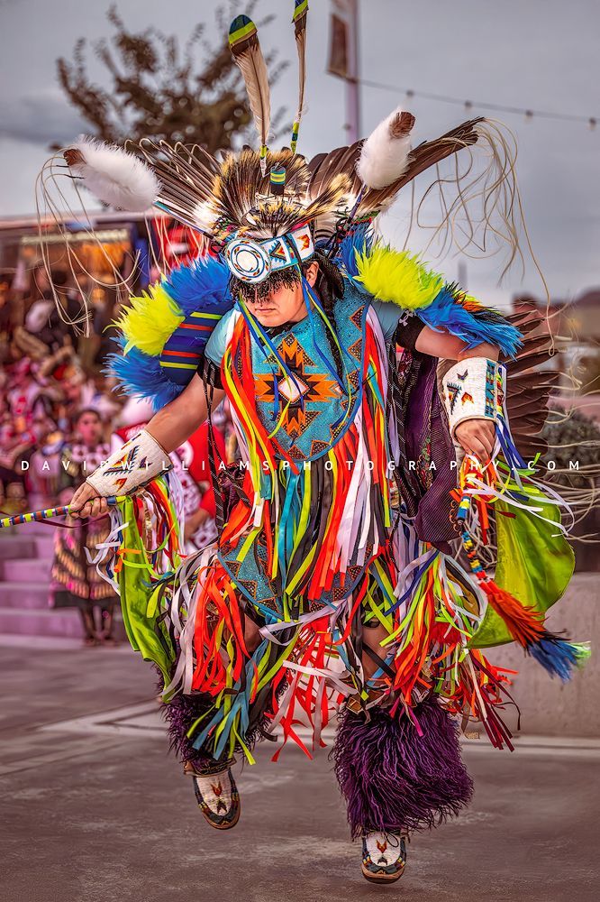 Full frontal vertical portrait of a Navajo Indian performing a traditional War Dance in full colorful regalia, captured as a fine art storytelling image.
