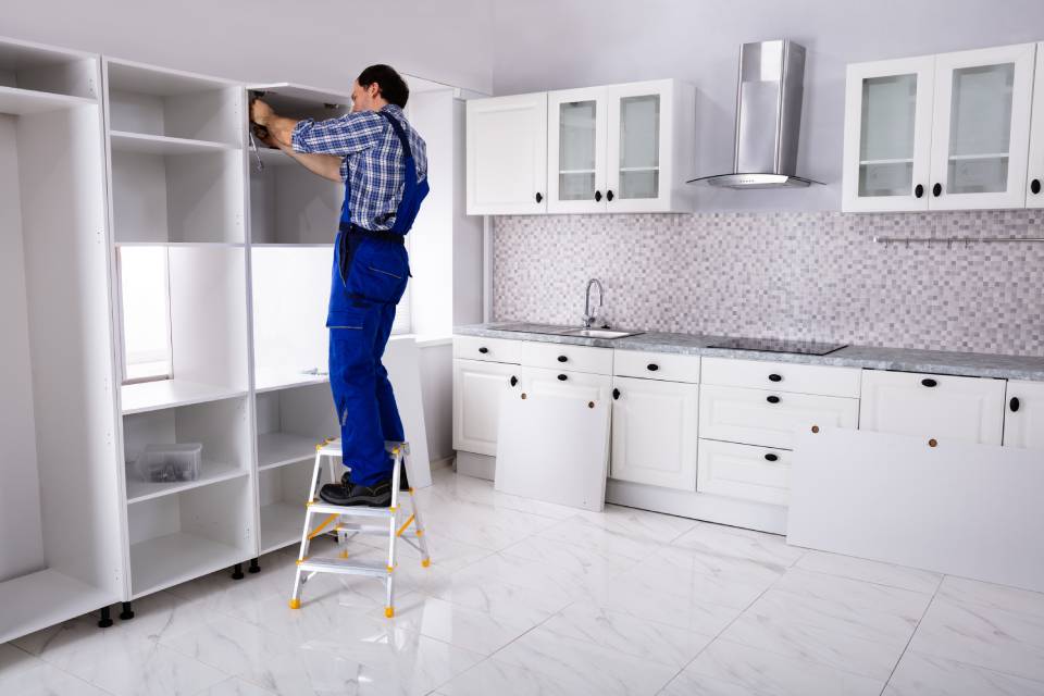 a carpenter completing a kitchen construction