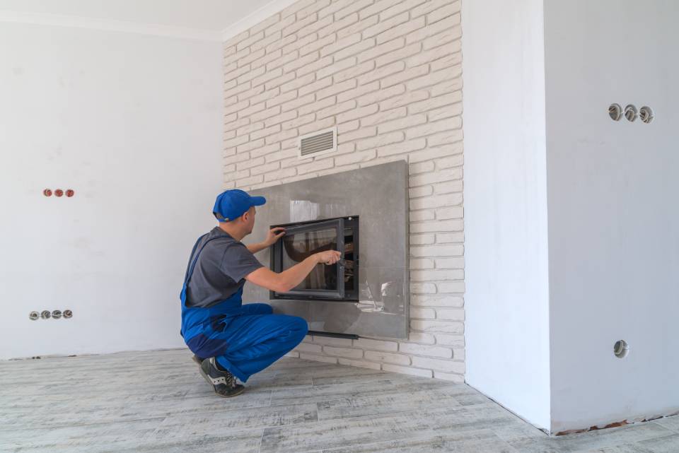a man constructing a fireplace