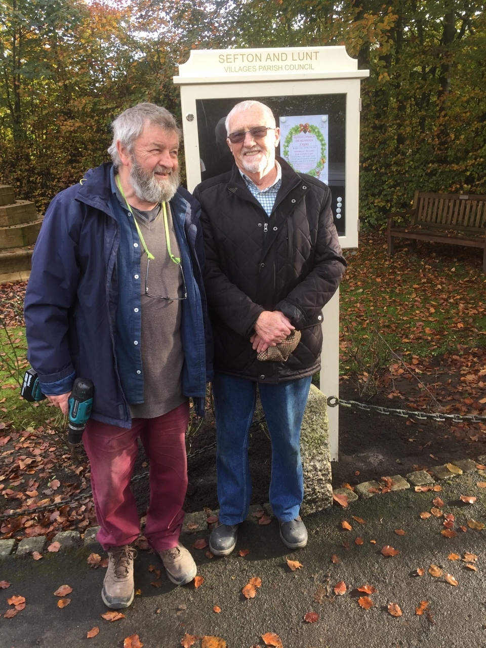 Councillors Lee and Greason installing the new notice board in Sefton Village