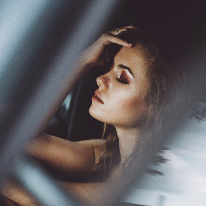 Woman touching her forehead, illustrating stress-related symptoms resolved through Steady Sense.
