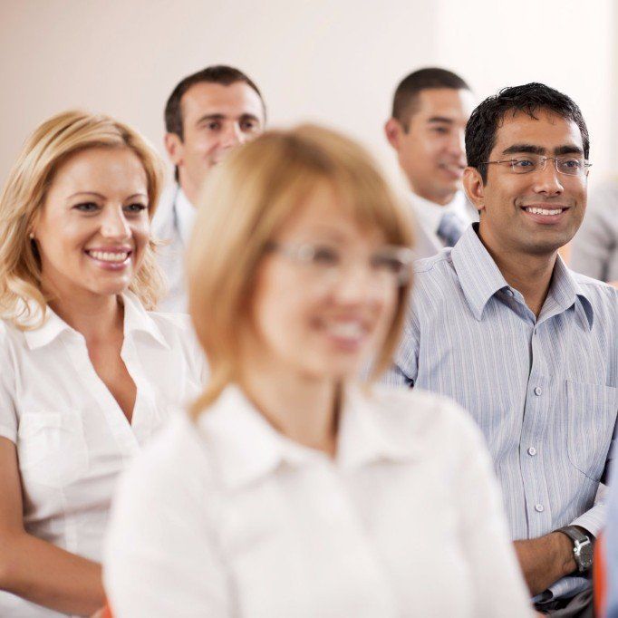 Smiling participants in a mental health seminar and group training by Steady Sense.