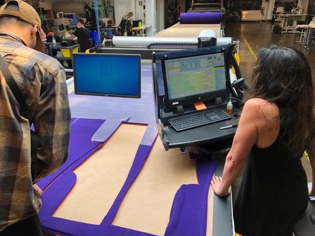 Design people working with computerized cutting table