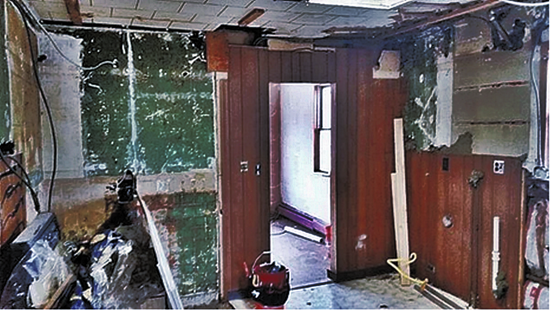 view of a small door opening in a 1900's home before renovation