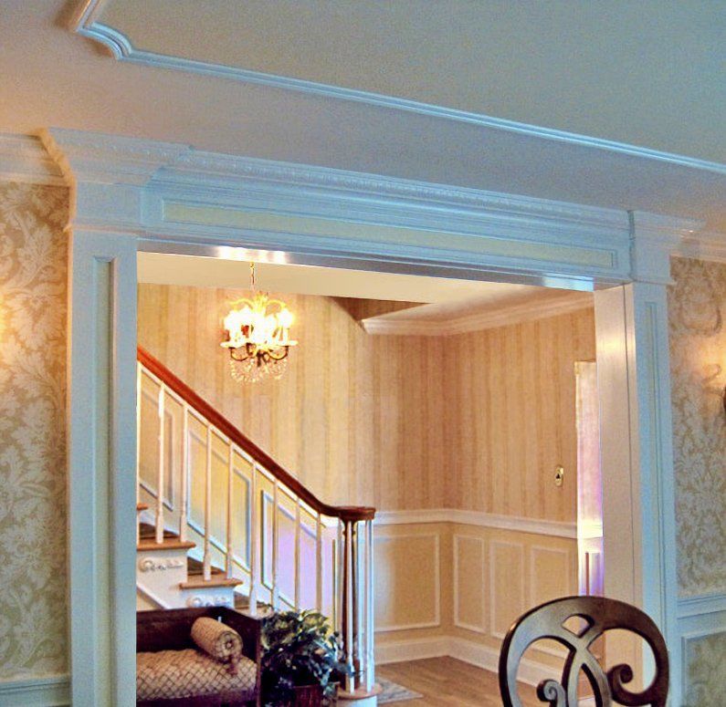 Molding added to the opening to a formal dining room by The Renovation Company