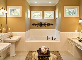 an upscale bathroom with white fixtures and gold walls