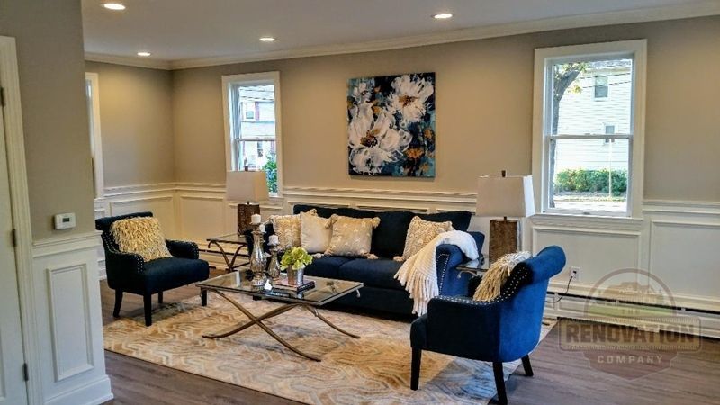Blue sofa and chairs with pillows in a living room