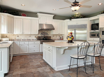 a gorgeous kitchen with white cabinets, stainless appliances and granite counters
