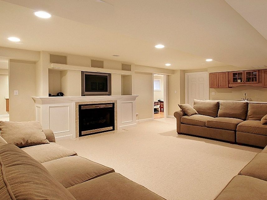 a remodeled basement with sofas, a fireplace, tv, and carpeting