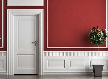 white wainscot molding on the lower wall, contrasted by a dark red wall above it