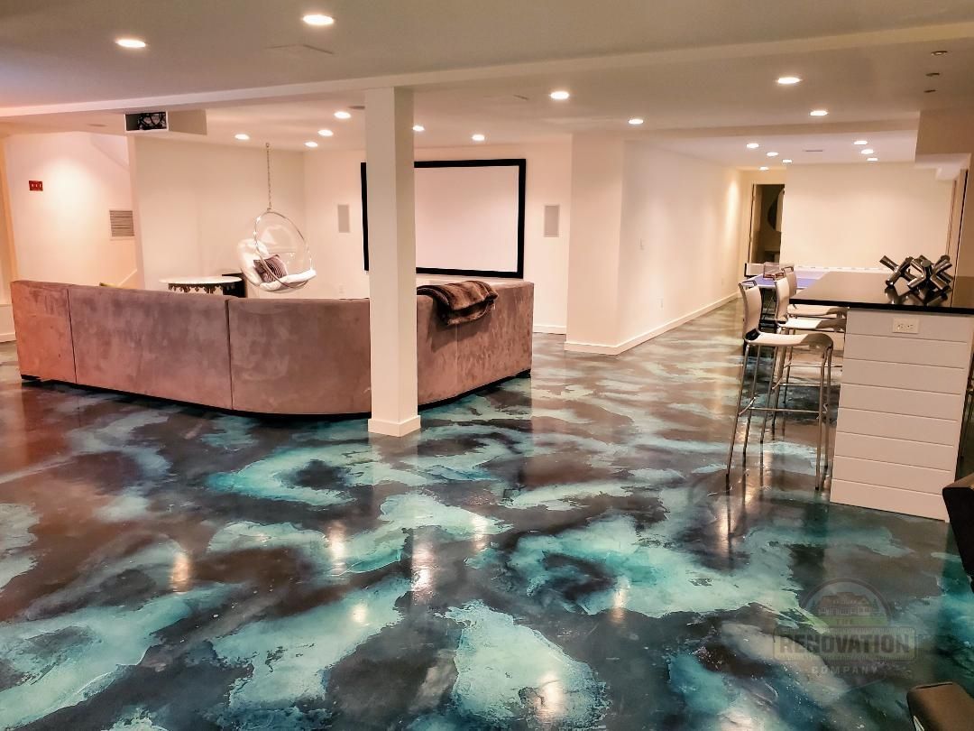 a remodeled basement with an unusual painted epoxy pattern on the floor