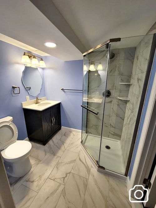 Full bathroom in the basement with a neo-angle shower
