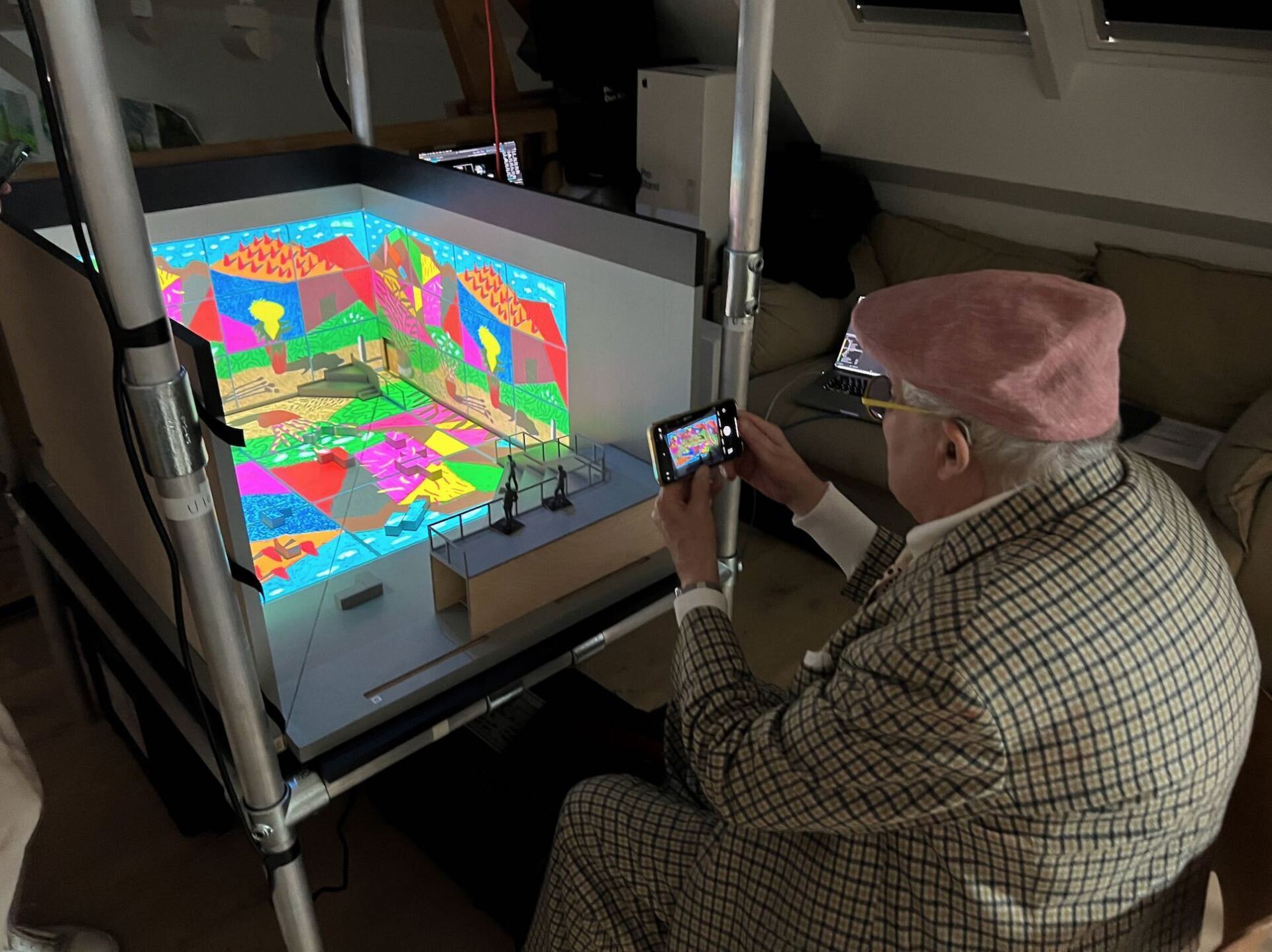 David Hockney viewing the model box containing