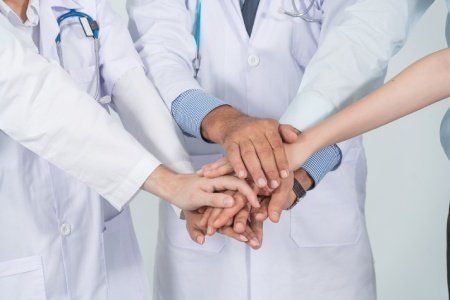 nurses joining hands