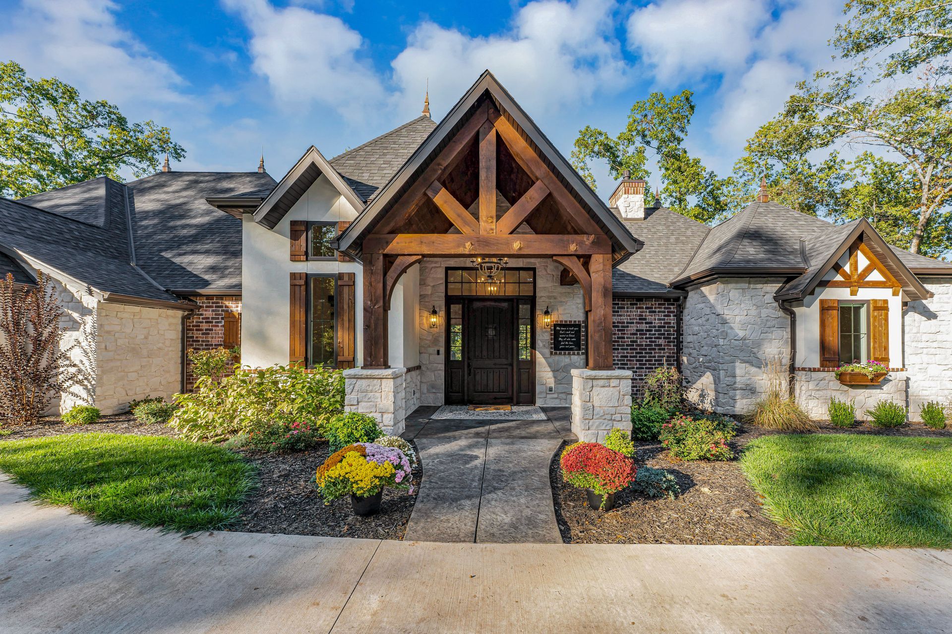 An exterior of the entry way of a beautiful home. Professional real estate photo by Jennifer White Timeless Moments Photography. Home built by Old World Cottages near Springfield Missouri.