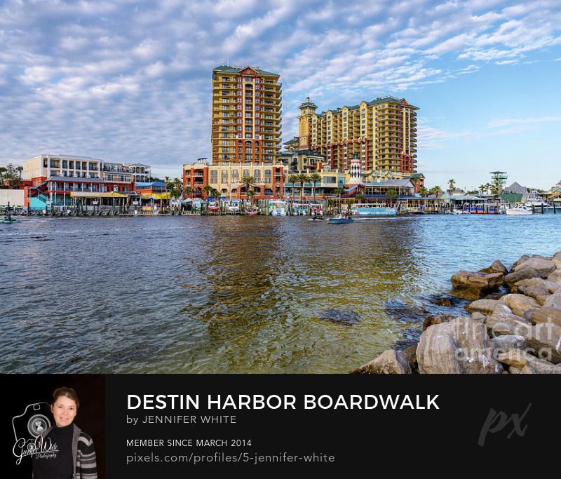 A view of the Destin Harbor Boardwalk area from across the Destin Harbor in Destin, Florida, United States. It's a really cool place to hang out with lots of shopping, food, and entertainment. This is also where a lot of the tour boat companies are located so there is a lot of boat traffic. You can see a little lighthouse in the middle of the buildings.