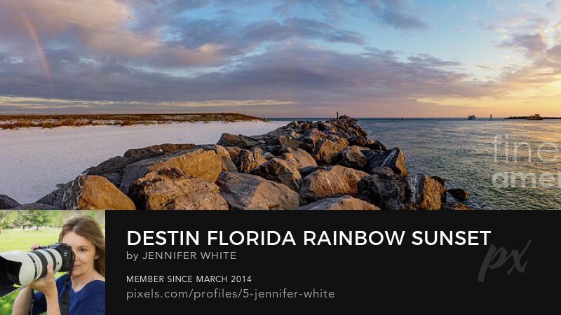 A fine art panorama photo of a sunset with a rainbow along the East Pass harbor area in Destin, Florida by Jennifer White with Timeless Moments Photography.