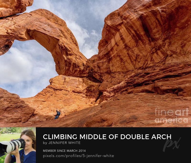 This photo helps give you a perspective of the majestic size of Double Arch in Arches National Park in Utah showing a man inside and under one of the arches.