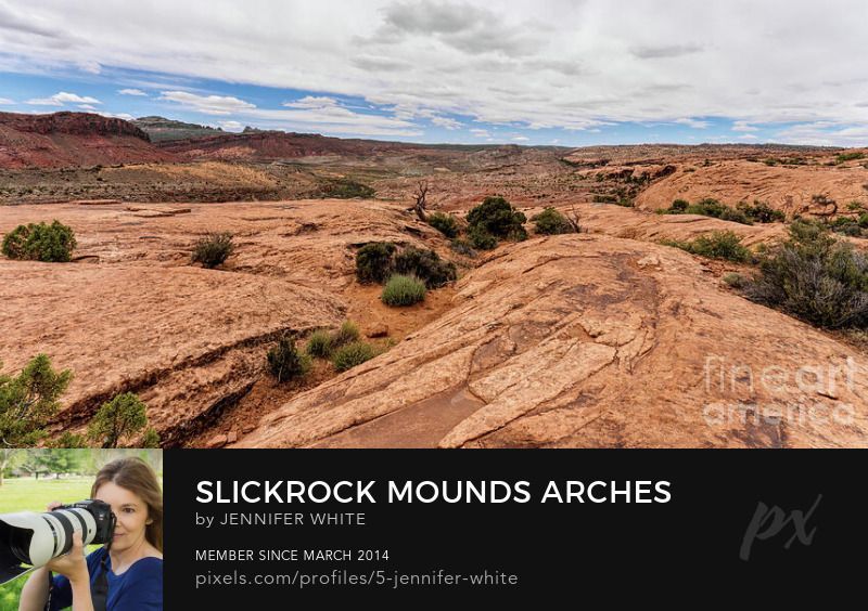 An expansive panorama view of some orange mounds and hills of slickrock in this desert landscape scene I captured along the hiking trail to Delicate Arch in Arches National Park.