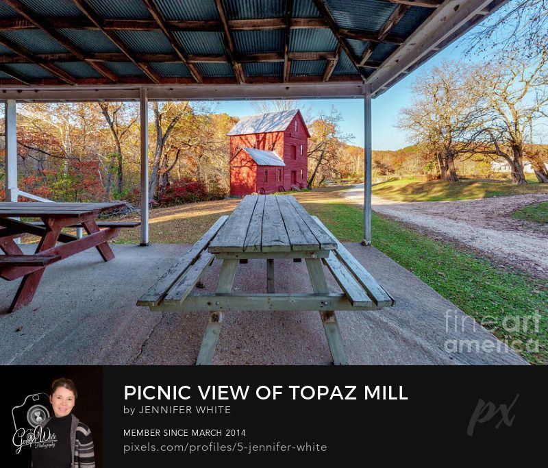A unique view of the historic red Topaz Mill while standing under the covered patio of the old vintage General Store. I centered a picnic table right in the middle with the mill in the back. The gravel road that runs in front of the store and grist mill crosses the North Fork river just on the other side of the mill. This grist mill was built in 1895. There was a mill before it that was built in 1840 but they don't really know what happened to it. The white building used to be the general store and post office for the small town.
This photo was taken by Jennifer White with Timeless Moments Photography. All images are copyrighted © Timeless Moments Photography/Jennifer White.