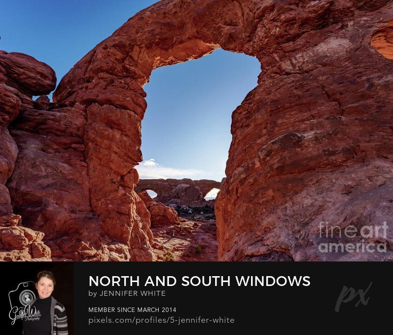 In this photograph, I captured a view of the North and South Window Arch rock formation while looking through the opening of the Turret Arch in Arches National Park. Located in Moab, Utah, we had been hiking around the windows section of the parch to capture the sunrise. It was a beautiful morning to explore these iconic cool large red rock formations. Just to give you an idea of the massive size, you can see a photographer walking around below the Turret Arch. They are so large and majestic.