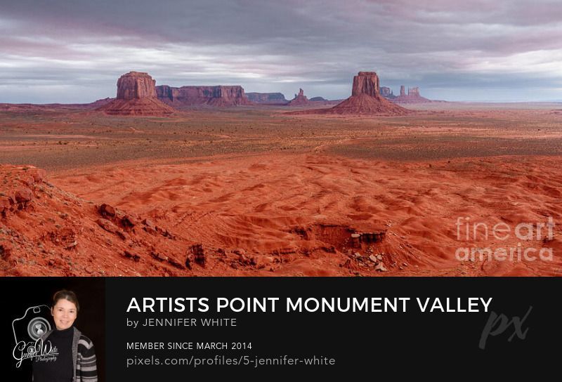 This panoramic photograph captures a sweeping view of Monument Valley in Arizona, USA, taken from the Navajo Code Talker Outpost, also known as Artists Point. I watched a powerful storm roll in, just moments before hail, sleet, and even snow fell across the desert, a rare sight in this iconic landscape. The warm orange and red tones of the sandstone terrain contrast sharply with the dramatic blue and purple storm clouds above. In the distance, several of Monument Valley’s famous formations stand proudly, including East Mitten, Merrick Butte, Mitchell Mesa, and others that define this legendary Southwest vista. Below, the loose sand and rocky formations of the Sand Springs region create intricate patterns and textures that complete this rugged desert scene.