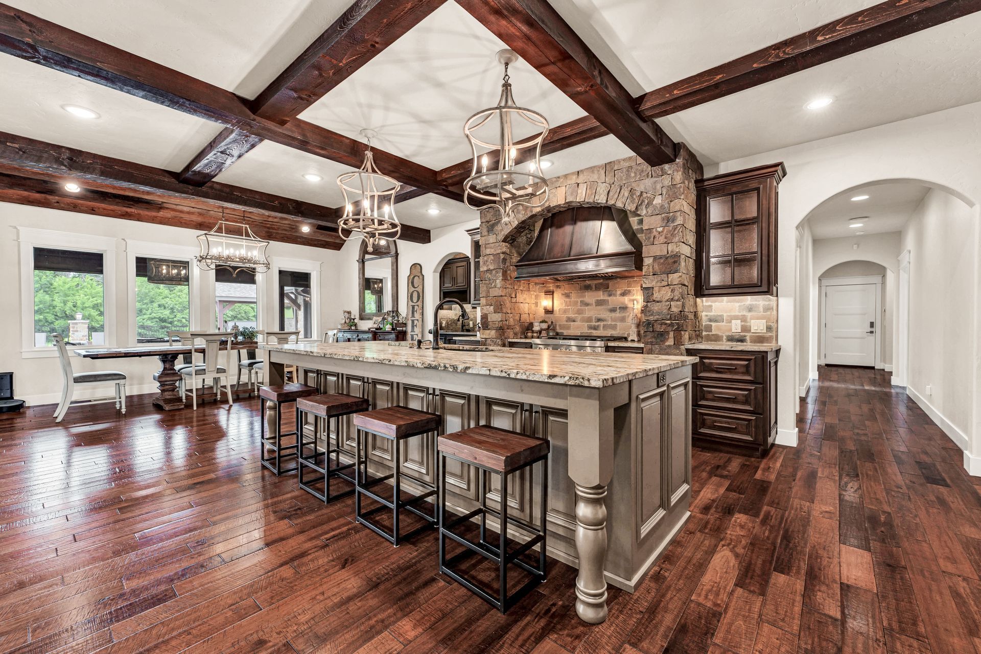 An interior angled photo of a luxury kitchen in Rogersville, Missouri. Professional photo by Jennifer White Timeless Moments Photography. Home built by Old World Cottages near Springfield Missouri.