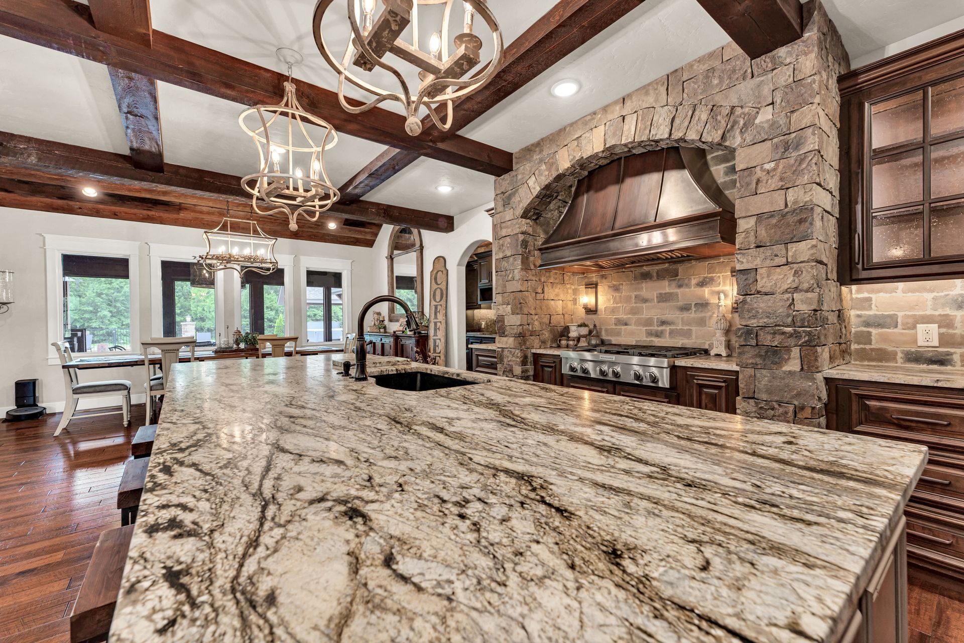A interior showing the granite counter top of a luxury kitchen in Rogersville, Missouri. Professional photo by Jennifer White Timeless Moments Photography. Home built by Old World Cottages near Springfield Missouri.
