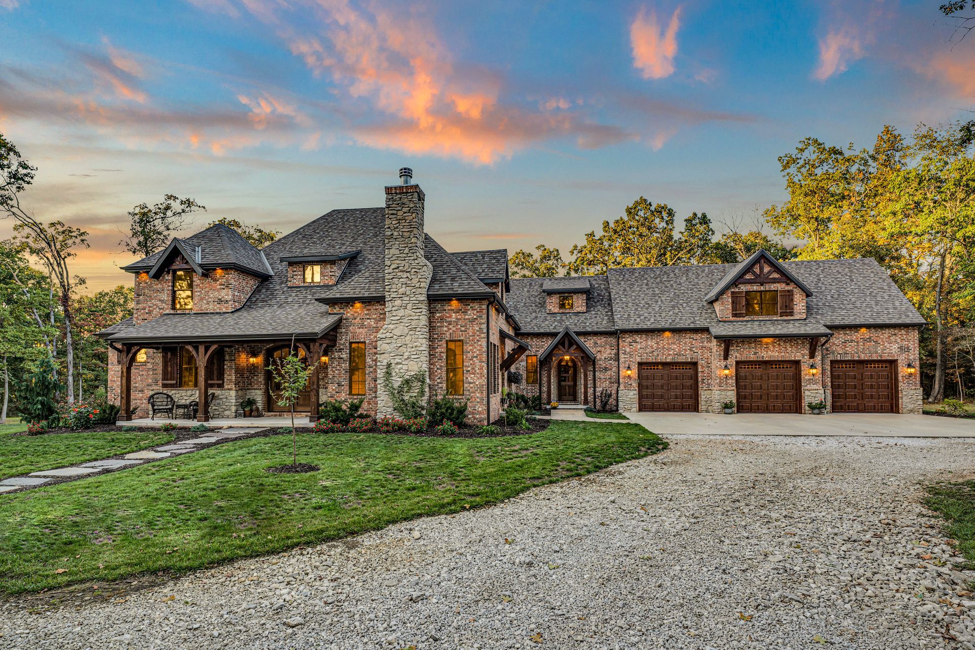 Real Estate Photography by Jennifer White Timeless Moments Photography of a home built by Old World Cottages near Springfield Missouri. This is an exterior dusk sunset scene.