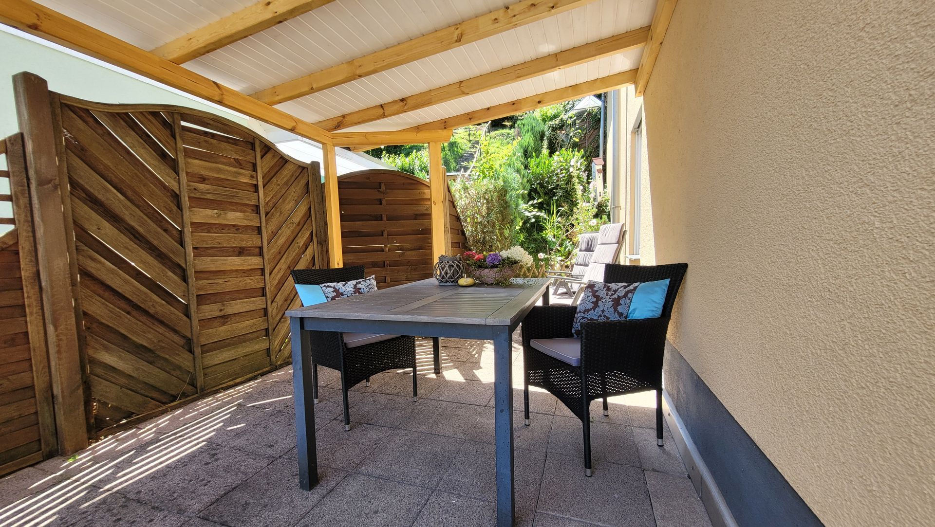 überdachte Terrasse mit Hanggarten