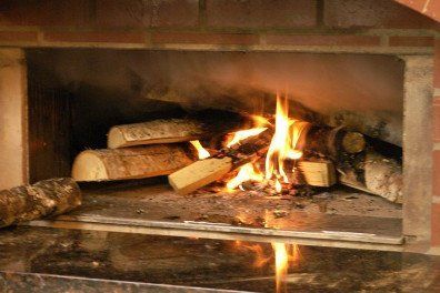Birch logs burning in wood fired oven ©Flying Squirrel Bakery Cafe, LLC