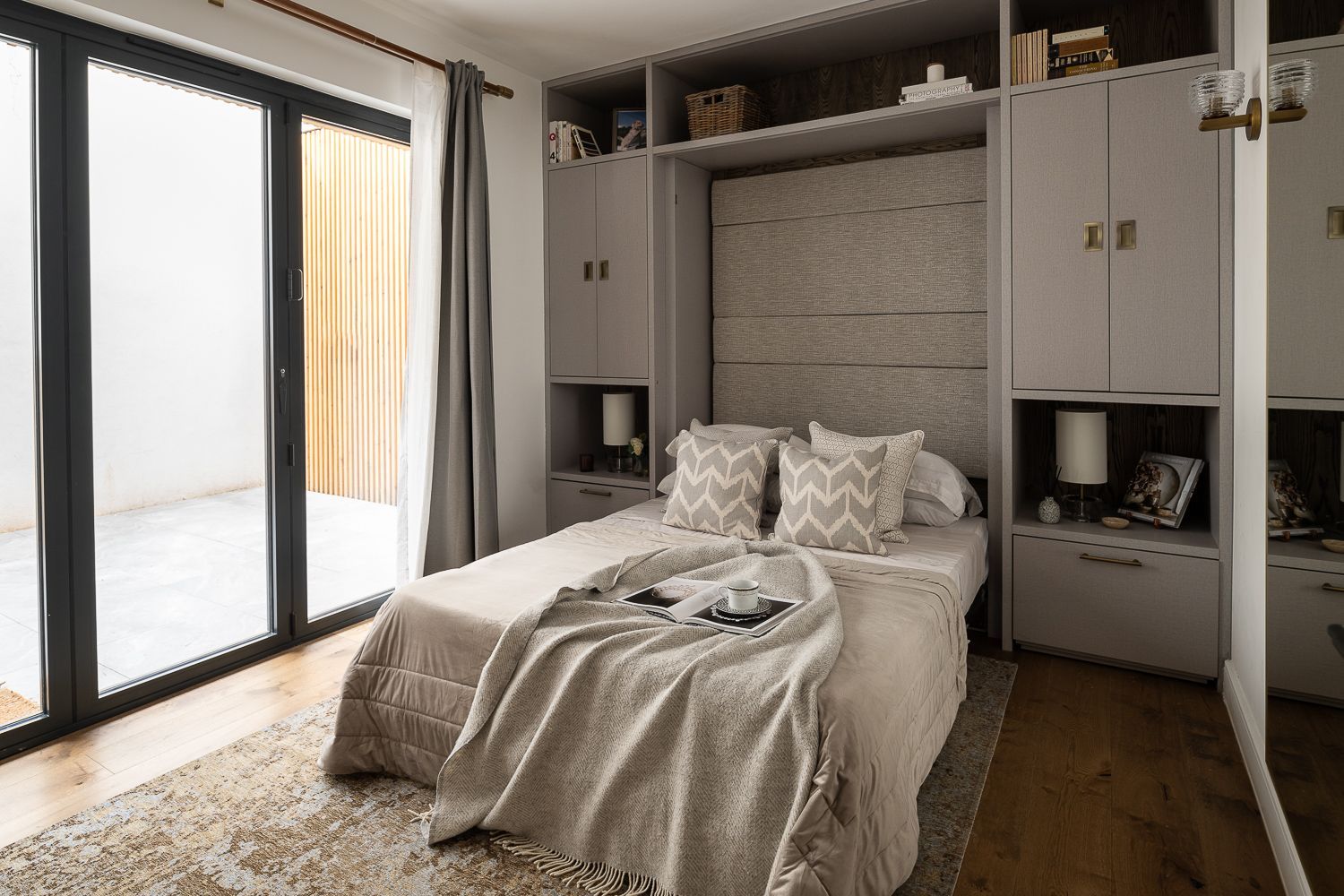 A luxurious guest bedroom with a Murphy bed seamlessly integrated into the built-in unit.innovative