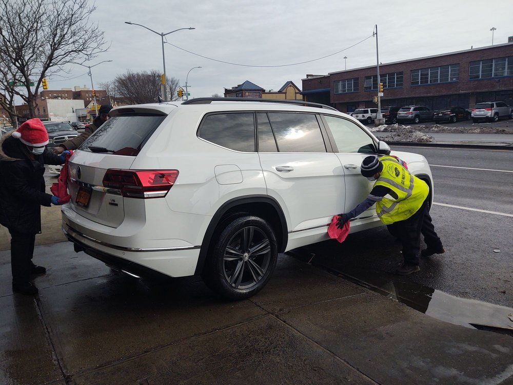 workers wiping a car dry