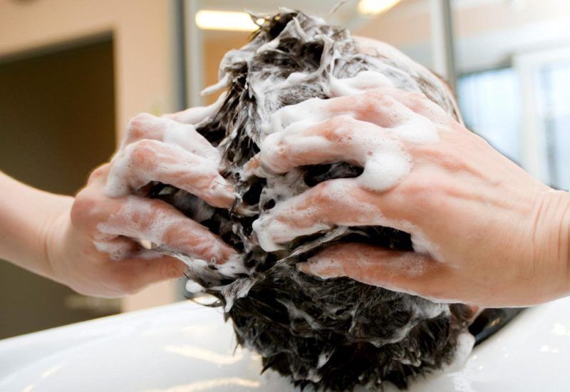 Man's hair being shampooed in a salon