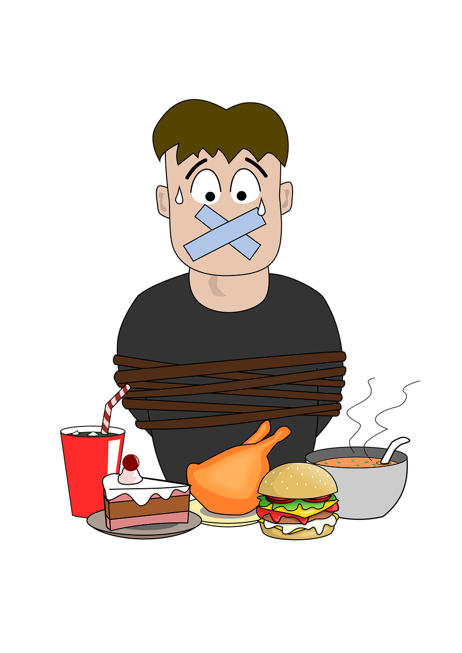 Diese Tipps helfen Dir dabei, auf Süßes und weitere Leckereien zu verzichten. Heißhunger abschalten. Mann sitzt mit zugeklebtem Mund vor Leckereien.