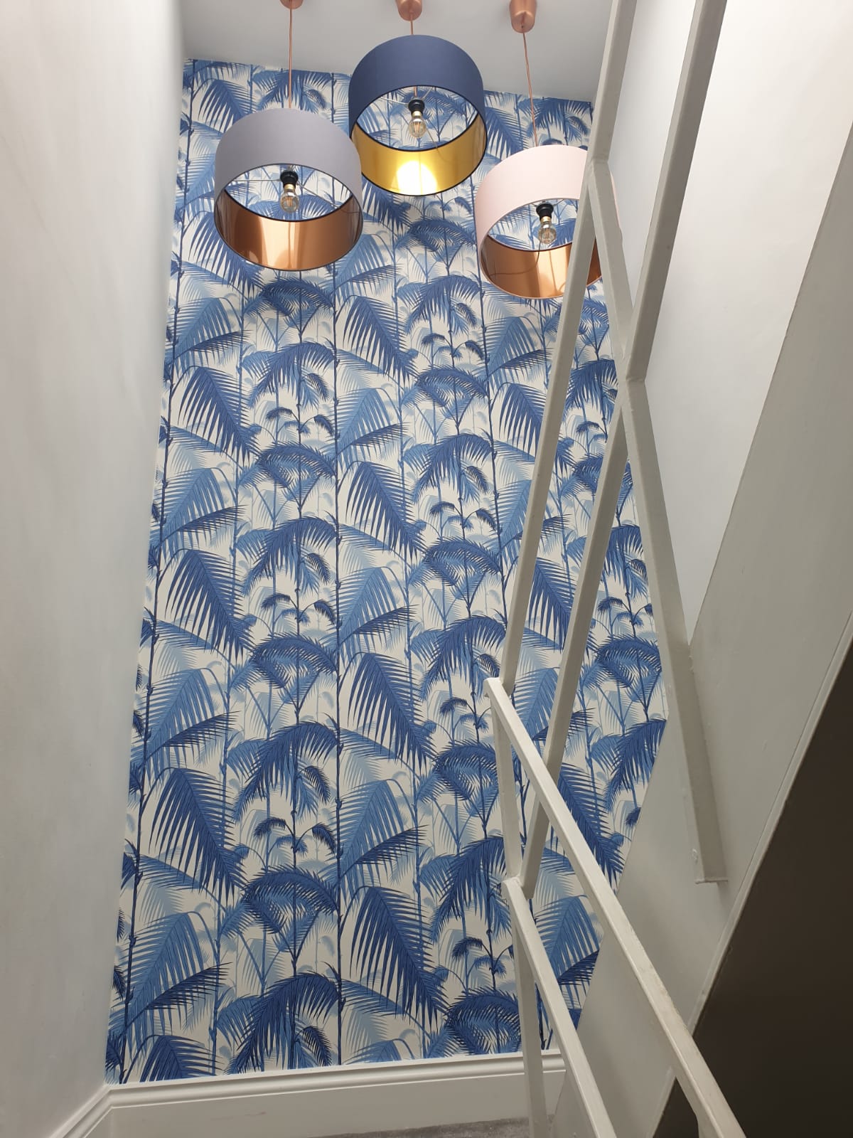 blue and white wallpaper in a hallway