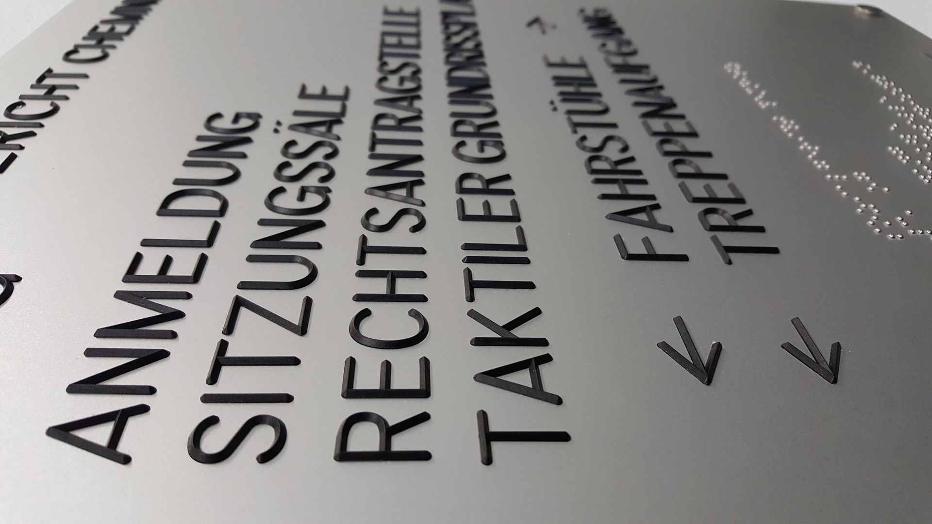 Unser speziell gestaltetes Wandschild ist eine ideale Orientierungshilfe für öffentliche Einrichtungen und Bürogebäude. Es weist deutlich den Weg zur Anmeldung und zu den Sitzungssälen. Der Text ist klar lesbar und zusätzlich in Brailleschrift übersetzt, um Barrierefreiheit für sehbehinderte und blinde Personen zu gewährleisten. Dieses Schild kombiniert Funktionalität mit inklusivem Design, erleichtert die Navigation in Gebäuden und fördert eine zugängliche Umgebung für alle Besucher.