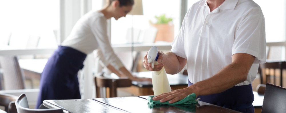 Man cleaning a table