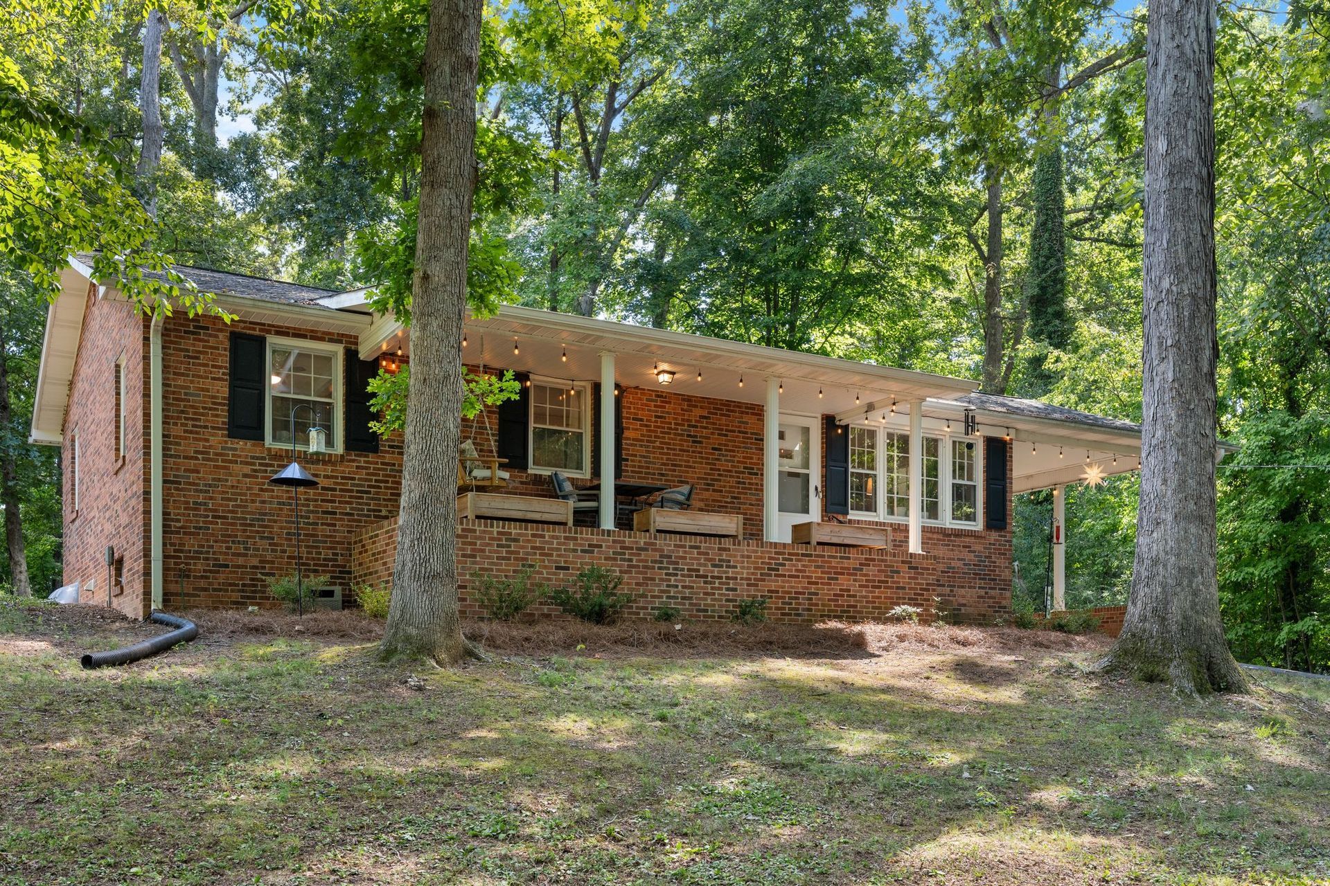 Brick Rancher on a wooded lot with covered front porch