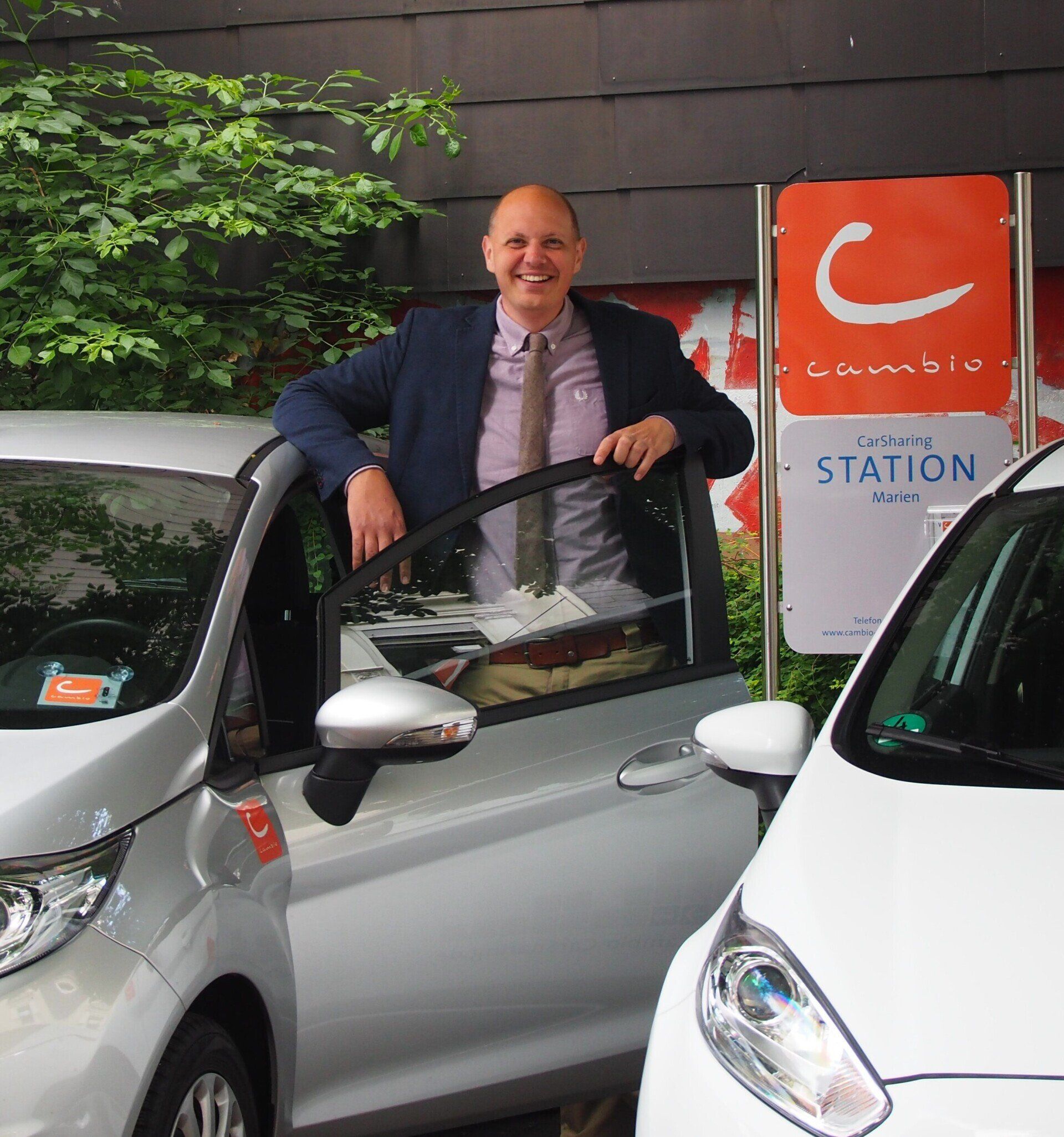 Henrik Hallmann an ein Cambio-Auto gelehnt