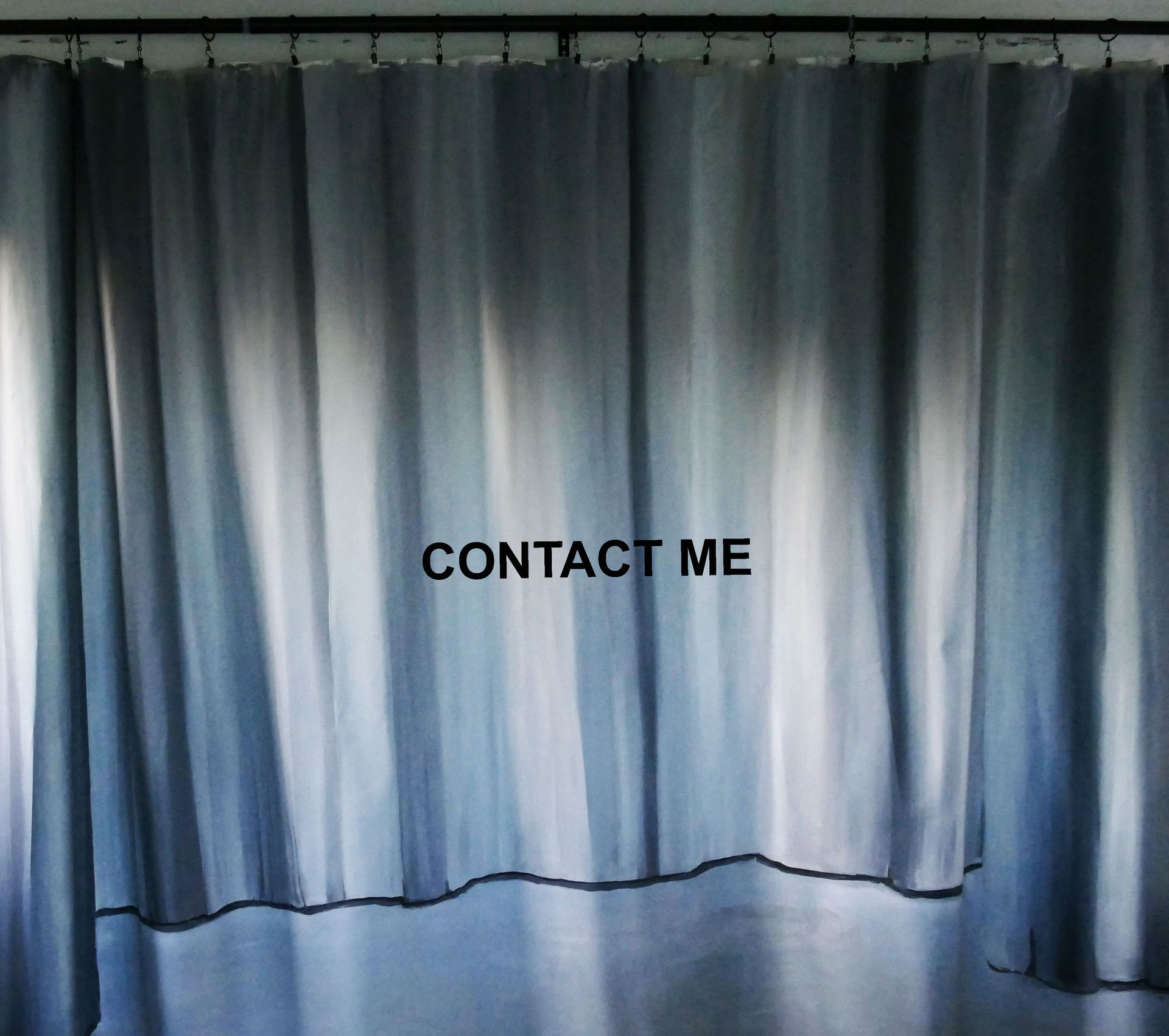 Image of a curtain with the words Contact Me across the middle of the image