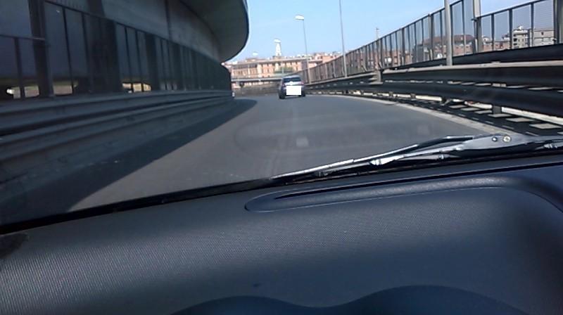 Someone busy taking notes, with a computer in front of them.